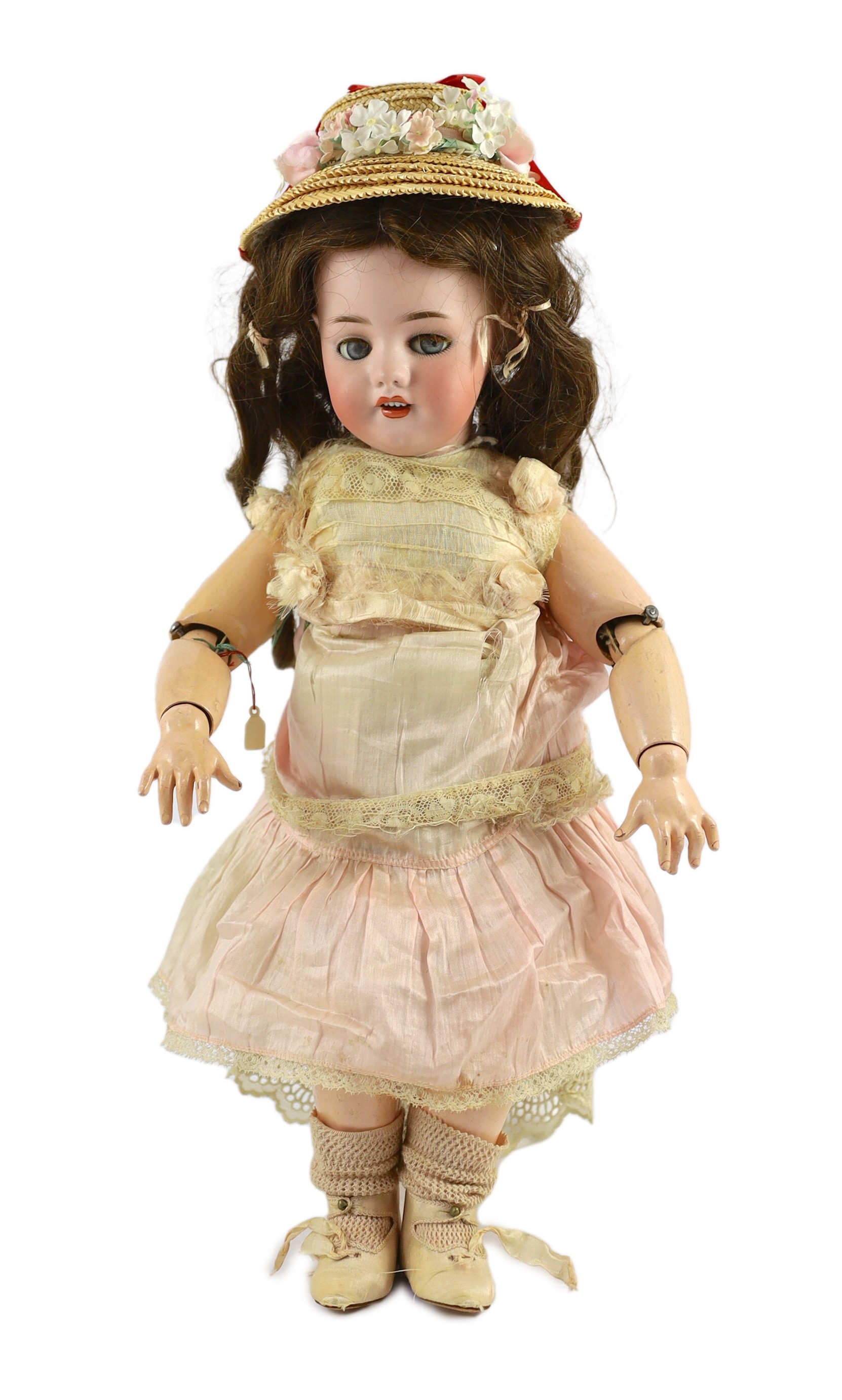 A rare Simon & Halbig walking kiss-blowing bisque doll, German, circa 1891, 22in.